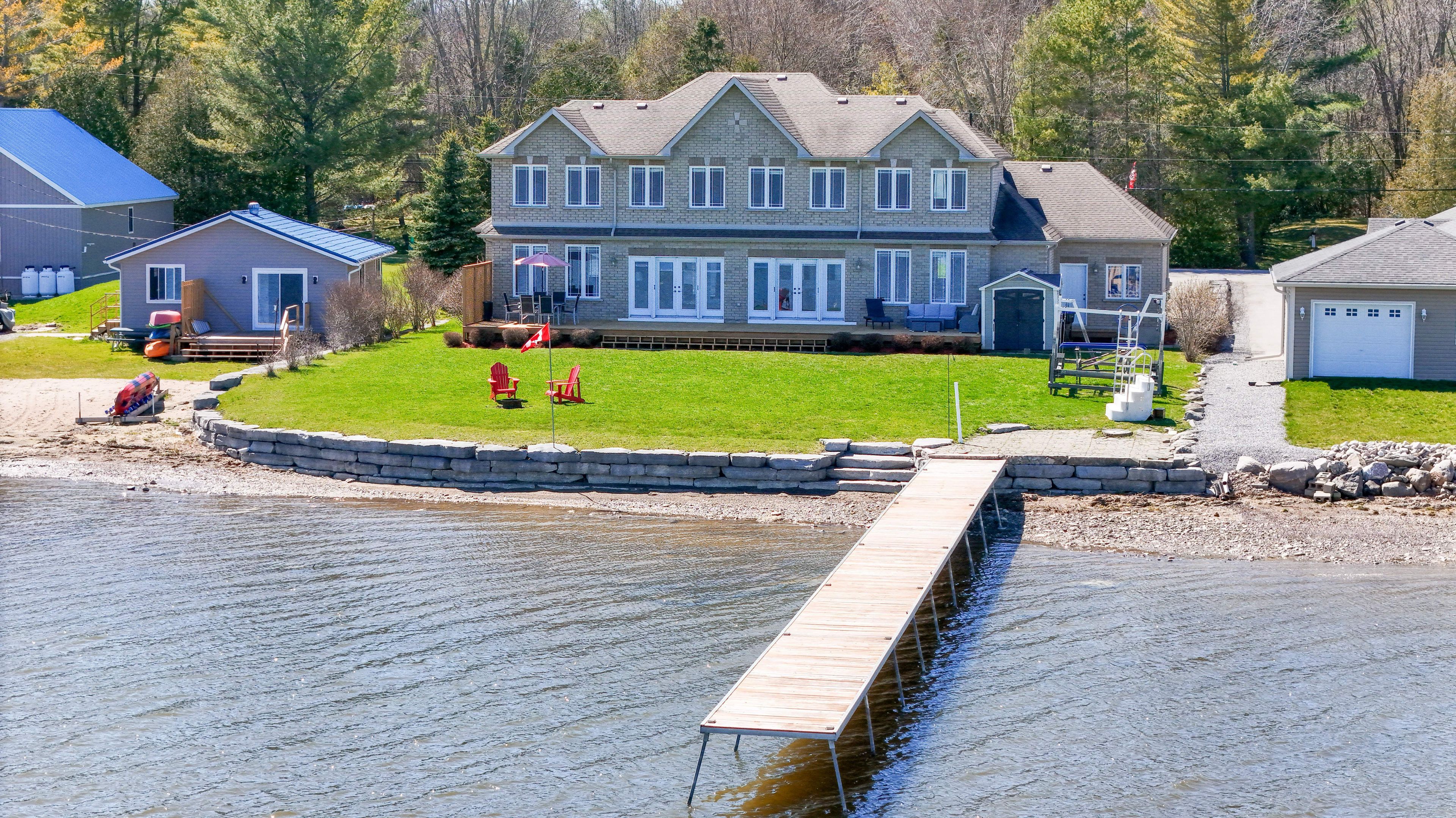 Welcome to your custom-built waterfront retreat nestled along the stunning shores of Georgian Bay. With 4 to 7 bedrooms and 6 bathrooms, this spacious home offers ample room for family and guests  or for hosting as an ideal Airbnb getaway or VRBO. Set on just over half an acre of land, you'll enjoy both tranquility and privacy, along with a 100-foot dock perfect for boating, swimming, or simply soaking in the sunset views. The expansive outdoor spaces are ideal for entertaining, relaxing by the fire pit, or dining al fresco while taking in panoramic views of the bay. Inside, the home features a sunroom for year-round enjoyment of the scenery, a gourmet kitchen and a dedicated home office. The partially finished basement offers additional space for recreation or storage. Whether you're seeking a luxurious full-time residence, a vacation home, or a short-term rental opportunity, this property is move-in ready and thoughtfully designed for comfort, style, and convenience. Wake up to breathtaking sunrises and embrace the beauty of waterfront living and the opportunity to share it through a high-performing Airbnb rental in one of Ontario's most desirable destinations.