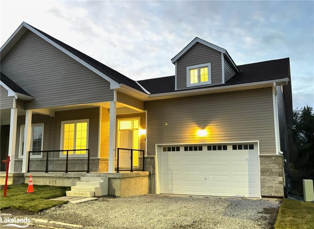 View of front of house featuring a porch and a garage