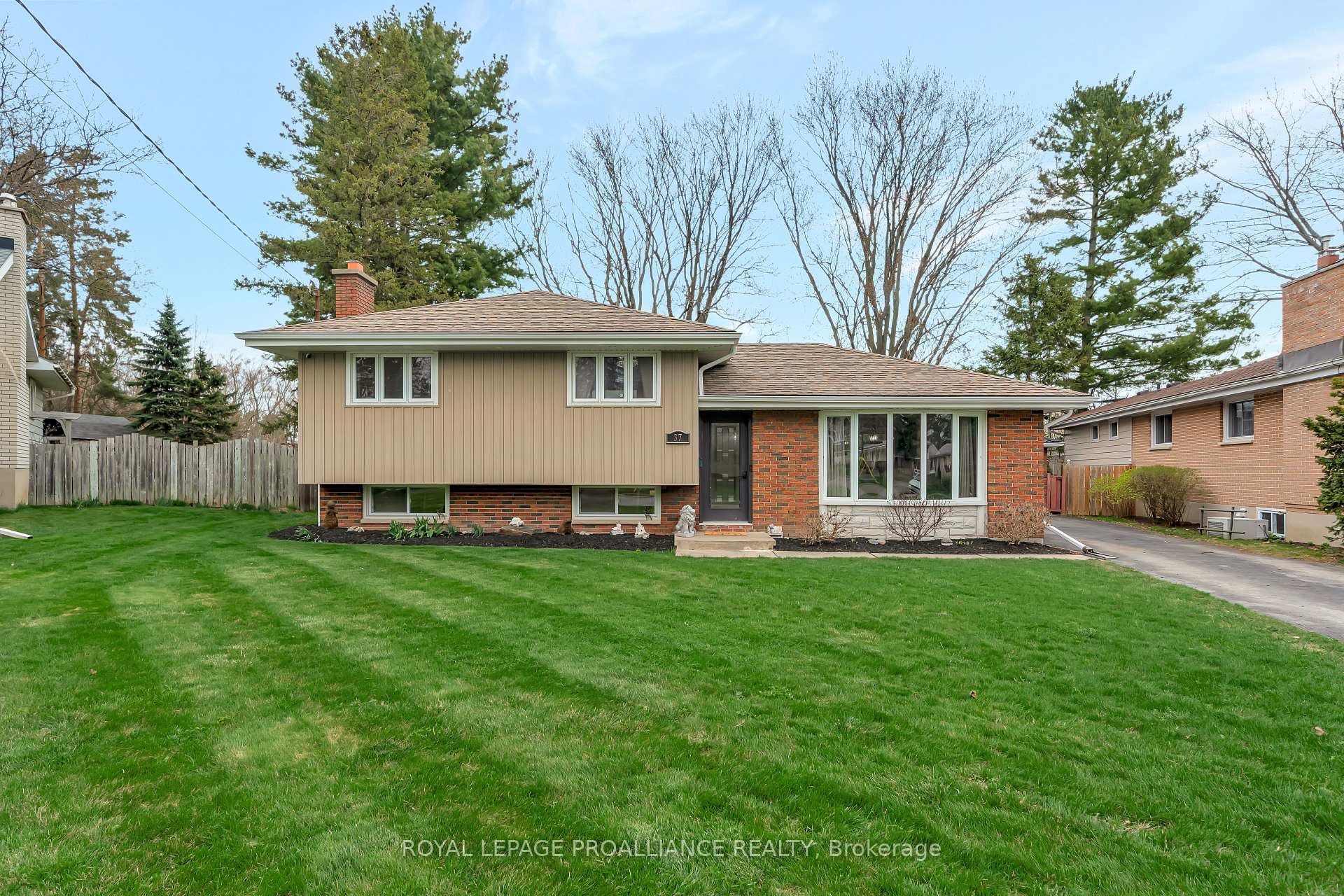 37 Applewood Drive Belleville, Ontario This a well-maintained three level sidesplit family home offers a functional layout and desirable features throughout. Located on a quiet cul-de-sac, the property incudes a detached one-car garage and a fully fenced backyard with a covered deck-perfect for relaxing or entertaining outdoors. The main level features a bright living room with hardwood flooring and a large bay window, a dining room, and am updated kitchen with a walkout to the rear yard and deck. Upstairs, you'll find three bedrooms, all with hardwood flooring, and a 4-piece bathroom. The lower level offers a spacious recreation room with new vinyl flooring and an electric fireplace, along with a 3-piece bathroom and a laundry room for added convenience. This home combines comfort, style, and a family-friendly location!