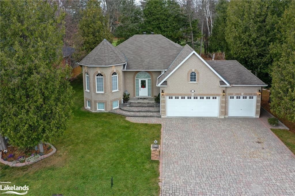 View of front of house featuring a front yard and a garage