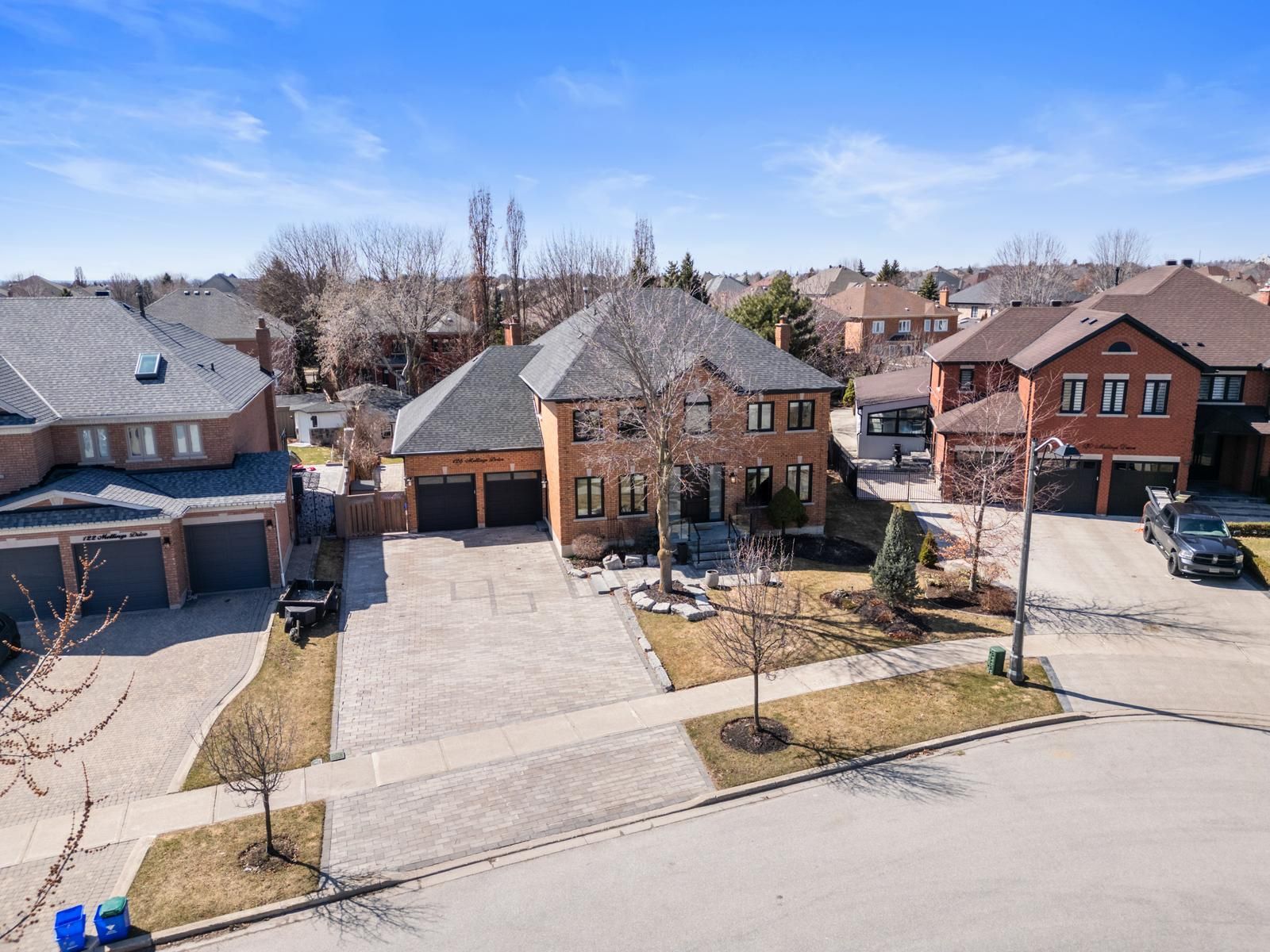 Welcome to 126 Mellings Drive, Vaughan - a rare offering in prestigious Weston Downs. Situated on one of the largest pie-shaped lots in the neighbourhood, widening to 113 feet at the rear, this fully renovated home offers nearly 4,000 square feet of luxurious living space. From the moment you step inside, you're welcomed by soaring cathedral ceilings, custom millwork, and premium marble finishes throughout. The heart of the home is an impressive gourmet kitchen, extended in 2021 to create an expansive layout with an oversized island, walk-in pantry, and bespoke cabinetry-perfect for entertaining or everyday living. The family room, also enlarged during the renovation, flows seamlessly off the kitchen, creating a spacious and inviting living area. This home features four large bedrooms, four fully renovated bathrooms, and a rare four-car tandem garage, currently converted into a home gym. Built in 1991, it has been thoughtfully upgraded to meet modern standards while retaining its classic charm. The unfinished basement offers a blank canvas for future customization. Outside, enjoy a beautifully landscaped backyard complete with two sheds, an interlocked patio, built-in BBQ area, and an irrigation system for effortless maintenance. The curb appeal is enhanced by a wide interlocked driveway and timeless exterior design. Located in one of Vaughan's most desirable communities, this is a truly unique home that combines elegance, functionality, and space in an unbeatable location.