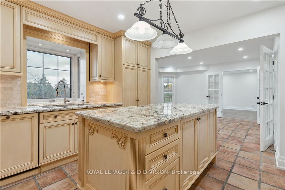 Island has 3 light pendant, granite counter