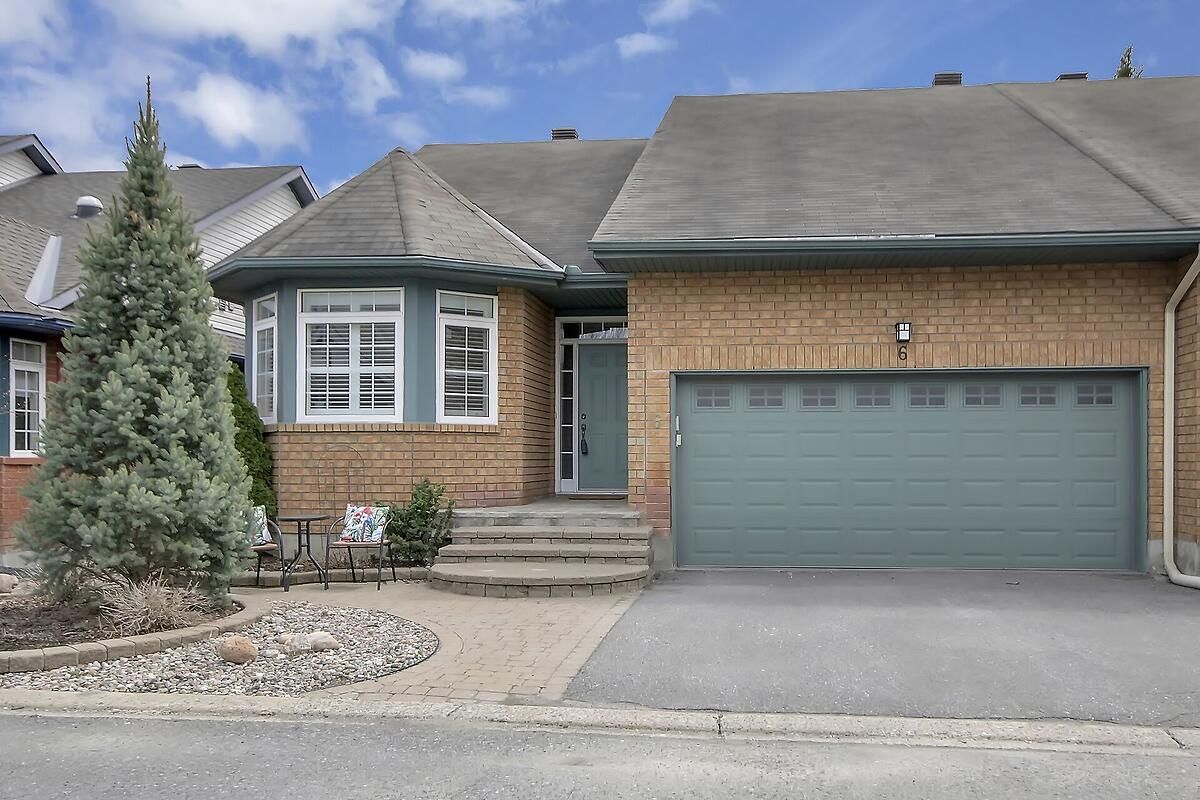 6 Briardale Crescent Cityview - Parkwoods Hills - Rideau Shore, Ontario A rare opportunity! This spacious, freehold bungalow townhouse is an end unit with a double garage, located on a quiet, picturesque street in a coveted central neighbourhood. It is the largest model in the development (1631 sq ft) and these units are seldom for sale. Both the front spacious foyer, and the convenient inside entry from the garage through a main floor laundry area, lead into exceptional living space with high cathedral ceilings, lots of natural light and hardwood floors in bedrooms, living and dining areas. The bright kitchen includes a pantry and a breakfast area that leads to a serene little sunroom with sliding glass doors opening out a two tiered deck and fully fenced backyard, perfect for entertaining and relaxing outdoors. The living room features a large picture window and a two-sided fireplace (breakfast area on the other side), and the adjacent dining room is open, airy and ideal for large gatherings. The primary bedroom, with blackout blinds, has walk-through closets to an ensuite bathroom with a soaker tub and a separate shower. Also on the main level is another full bathroom adjacent to the roomy second bedroom featuring a double closet and shutters on four bow windows. Downstairs, the carpeted basement provides 638 sq ft of extra living space with a third bedroom, a third bathroom and a family/TV room. The extra-large storage room (unfinished) houses the furnace (2020), electrical panel, and a utility sink. The homeowners association fee of $150/month includes snow removal from porches, steps, walkways and the street, as well as maintenance of the private street and other common elements.