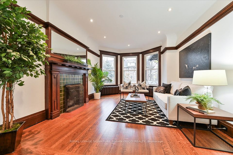 Main level living room with fireplace/ bay windows