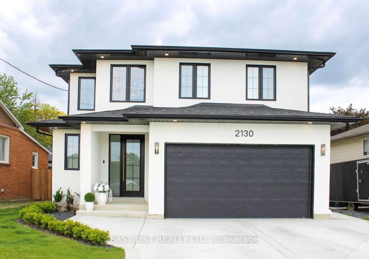 2130 Cabana Road W Windsor, Ontario For more info on this property, please click the Brochure button. Stunning Executive 2-Storey Home in Desirable South Windsor. Built in 2024, this beautifully designed 2-storey home boasts a modern white stucco exterior with executive finishes throughout. Step inside to find Engineered-hardwood flooring flowing seamlessly across the entire home, complementing the luxurious 8' doors on the main floor. The spacious open-concept kitchen features a large island with a quartz waterfall countertop, quartz backsplash, a wet bar, and a walk-in pantry. The adjacent mudroom off the garage adds functionality and convenience. The family room showcases a breathtaking TV/fireplace wall, complete with a large concrete-surrounded fireplace, large format tile, and custom wood finishes. This home offers 3 bedrooms and 3 bathrooms, including a luxurious 5-piece ensuite with large tile and custom wood finishes and two large walk-in closets. The home features a stunning custom steel powder-coated railing, adding a sleek, modern touch to the staircase, and second-floor laundry provides added convenience. This stunning 2-storey home is conveniently located just 1 km from St. Clair College and only minutes away from Huron Church Road, Highway 401, and E.C. Row Expressway, offering easy access to all major amenities and commuting routes. Additional highlights include a fully landscaped yard with a fence to be installed in spring, a custom wide-edge driveway design, a large rear patio with a sidewalk to a potential shed, a 2-car garage, and a grade entrance in the back yard to the basement. The unfinished basement has rough-ins for a bathroom and a kitchen/bar. Drywall is already in the basement, ready to be installed, which offers the potential to be finished to your specifications.