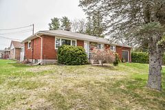 289 Patricia Avenue Pembroke, Ontario Charming 3+1 solid brick bungalow in the heart of Pembroke! Welcome to this well-maintained, solid brick home nestled on a desirable corner lot just steps away from schools and shopping. This warm and inviting home features 3 bedrooms and a full bathroom on the main floor, along with a formal dining room and a generous living room highlighted by a large picture window, and a functional kitchen with direct access to the private backyard! The fully finished lower level offers an oversized rec room, an additional bedroom, full bathroom, and ample storage! Outside, enjoy the mature, and private lot, with cedar hedges and patio! Do not miss this gem! 24 hour irrevocable on all offers.