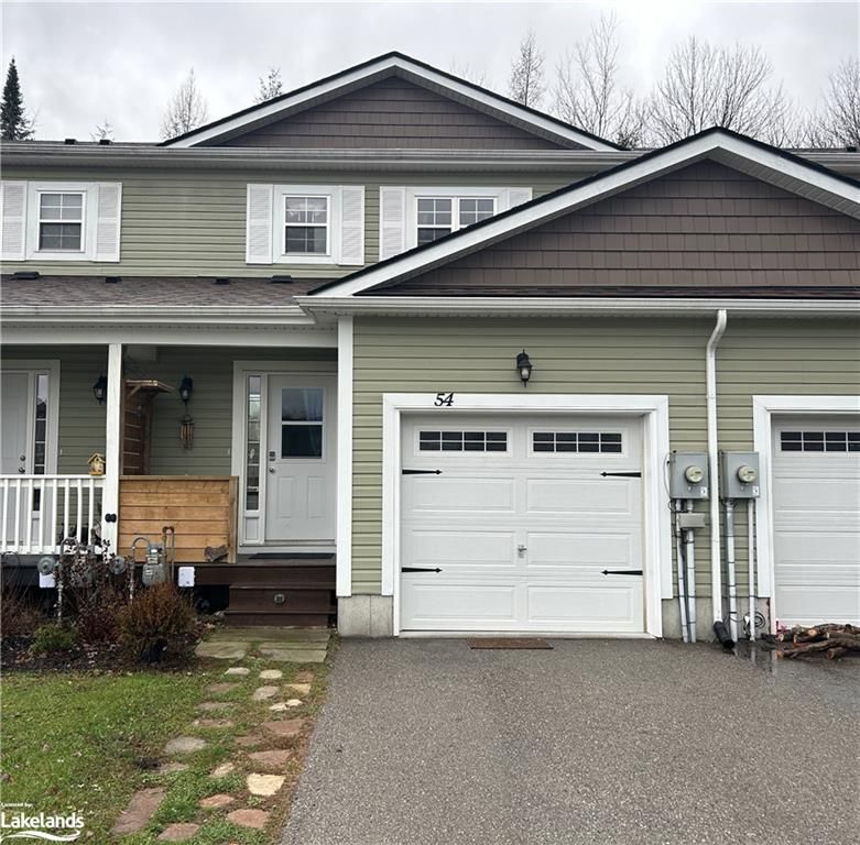 View of front of home with covered porch and privacy divider 
