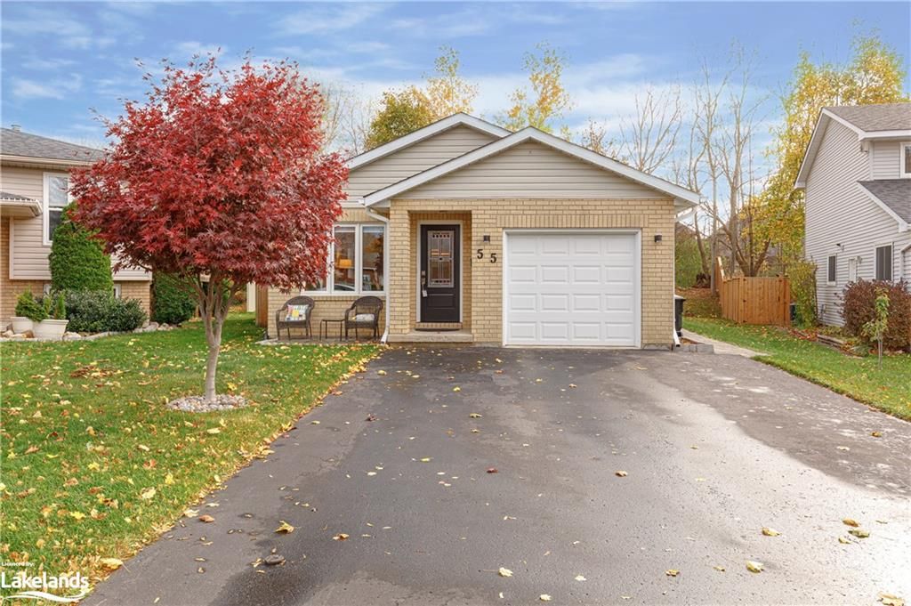 View of front of property with a garage and a front yard