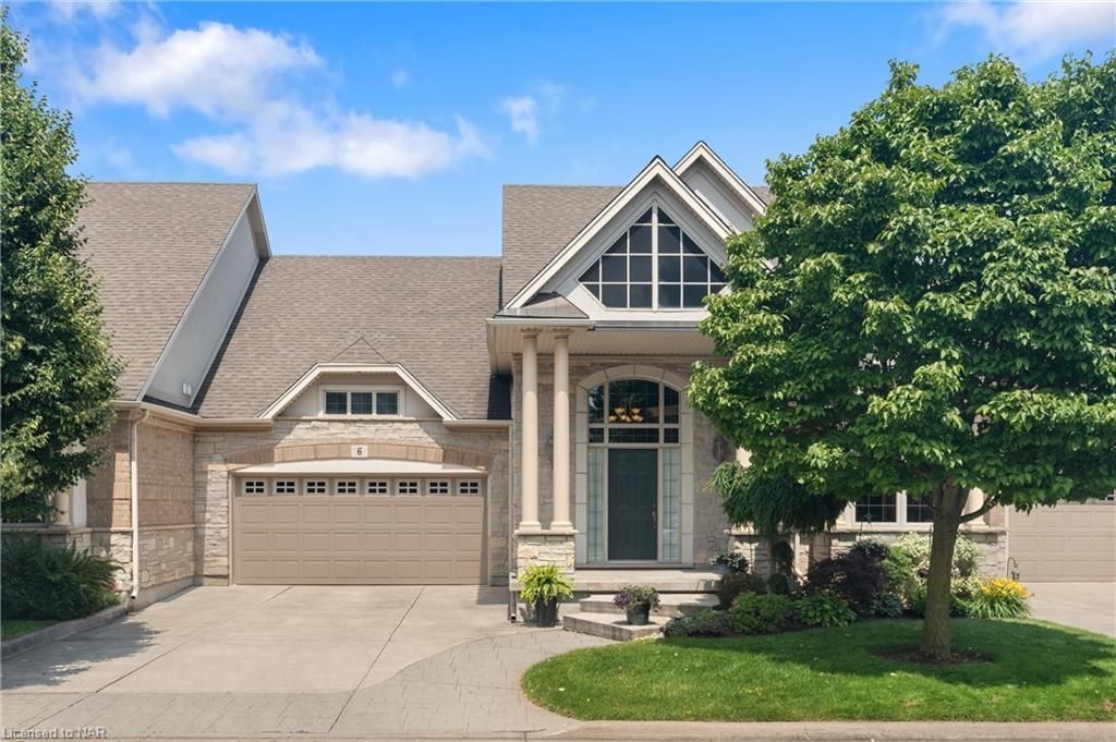 Beautiful exterior of stone with lovely windows, pillars & upscale lighting.