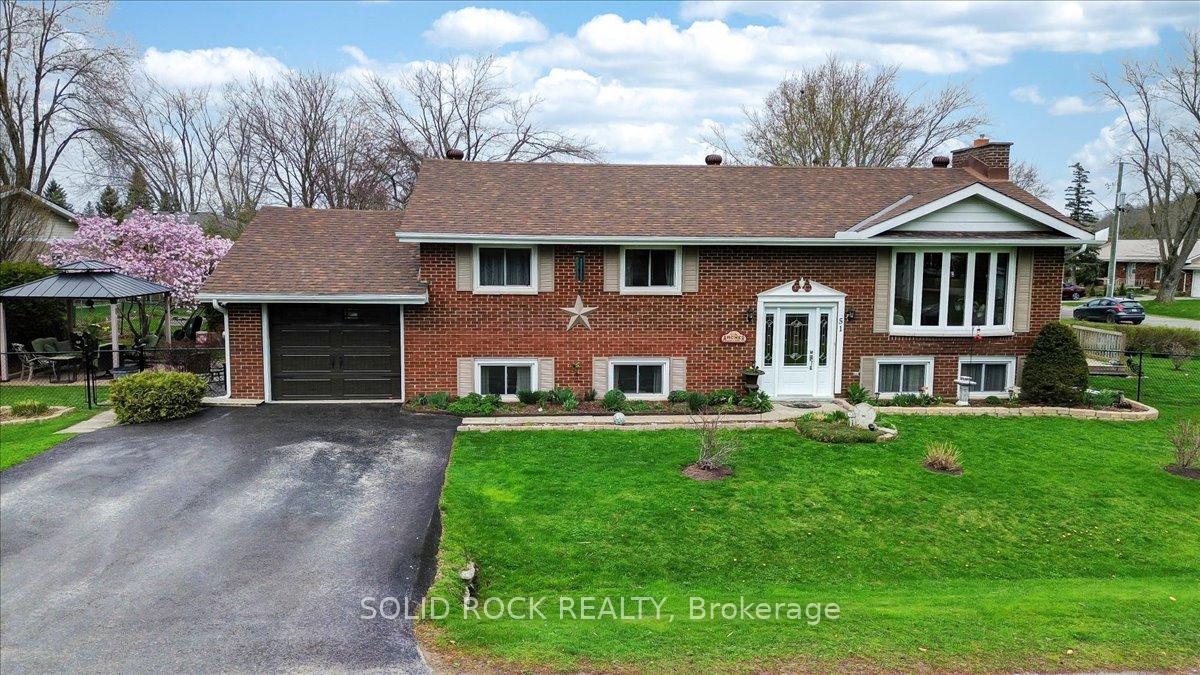 51 Gair Street Trent Hills, Ontario Just steps from the Trent Severn Waterway and the scenic Ranney Gorge Suspension Bridge and Ferris Park, this charming 3+1 bedroom, 2-bath raised bungalow is the perfect place to call home. Thoughtfully designed with family living in mind, it features two cozy gas fireplaces - one on each level adding warmth and comfort throughout. The living room has a large bay window that offers a great view of the outdoors. The generous primary bedroom includes semi-ensuite access for added convenience. It features his and hers sinks and a newly renovated bathtub/shower area with thoughtfully added large niche to hold all your favourite items for easy access. The spacious kitchen is ideal for entertaining, offering direct access to a back deck - perfect for summer barbecues and gatherings. Step down into your own private Zen Garden, a peaceful retreat bordered by mature landscaping and highlighted by a stunning magnolia tree in bloom. Whether you enjoy your favourite beverage, soak in the hot tub or simply reading a book, there is a sense of peace and tranquility. The fully finished lower level expands your living space with a welcoming family room, complete with a gas fireplace that invites relaxation and connection. The lower bedroom is very spacious and has 2 larger windows that let light in without the feel of being on a lower level. This room could also be used as an office or additional living living room space which is perfect for a larger family or perhaps teenagers needing their own space. There is entry to the house from the garage to the workshop/utility room. There are 2 heat pumps, one on each level. There is Gas hookup to the BBQ, Firepit and lower deck. Many Upgrades - check attachments for details. Located in a walkable neighborhood close to nature trails, downtown shops, and local amenities, this home offers the perfect blend of comfort, style, and lifestyle. Video Coming Soon