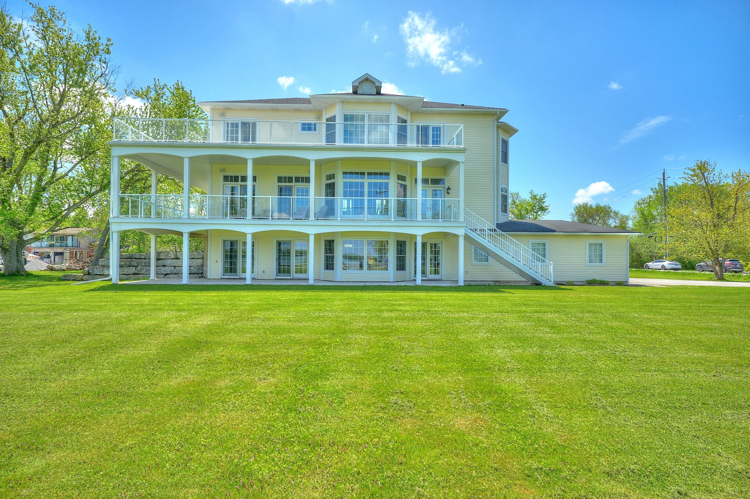 4069 Niagara River Parkway Parkway Fort Erie, Ontario Exceptional Custom Estate on the Niagara River with Private Dock. A rare opportunity to own a one-of-a-kind, custom-designed residence set on two manicured acres with commanding views of the Niagara River. This architecturally refined home blends timeless elegance with thoughtful functionality, featuring soaring 10-foot ceilings, rich hardwood floors, and floor-to-ceiling Andersen windows that flood the interior with natural light. Designed for both everyday living and exceptional entertaining, the home showcases top-tier finishes including marble and granite surfaces and three gas fireplaces. Car enthusiasts will appreciate the attached four-car tandem garage and separate heated four-car garage. Enjoy the tranquility of waterfront living from two expansive covered patios, or launch your boat from your private dock. With the Niagara Parkway Trail just steps away and the QEW minutes from your door, this home offers a lifestyle of rare beauty, privacy, and convenience. (dock permit is by annual renewal)