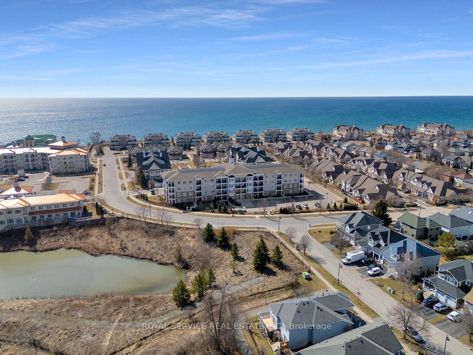 Back view of condo building, pond and Lake Ontario