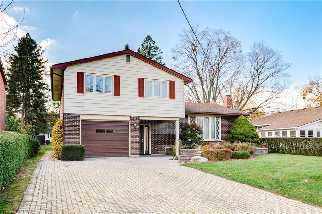 View of front of property with a garage and a front yard