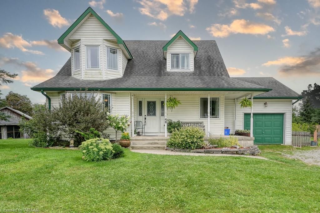 View of front of home with a front lawn, a garage, and a porch