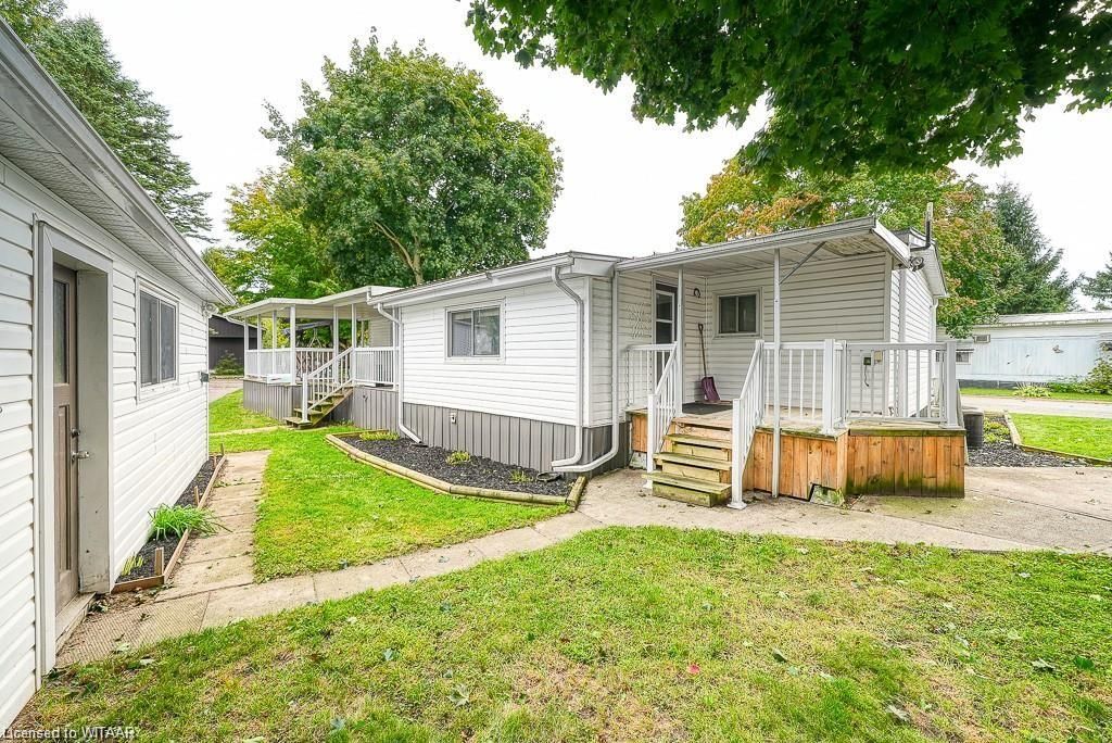 Back of property with a lawn