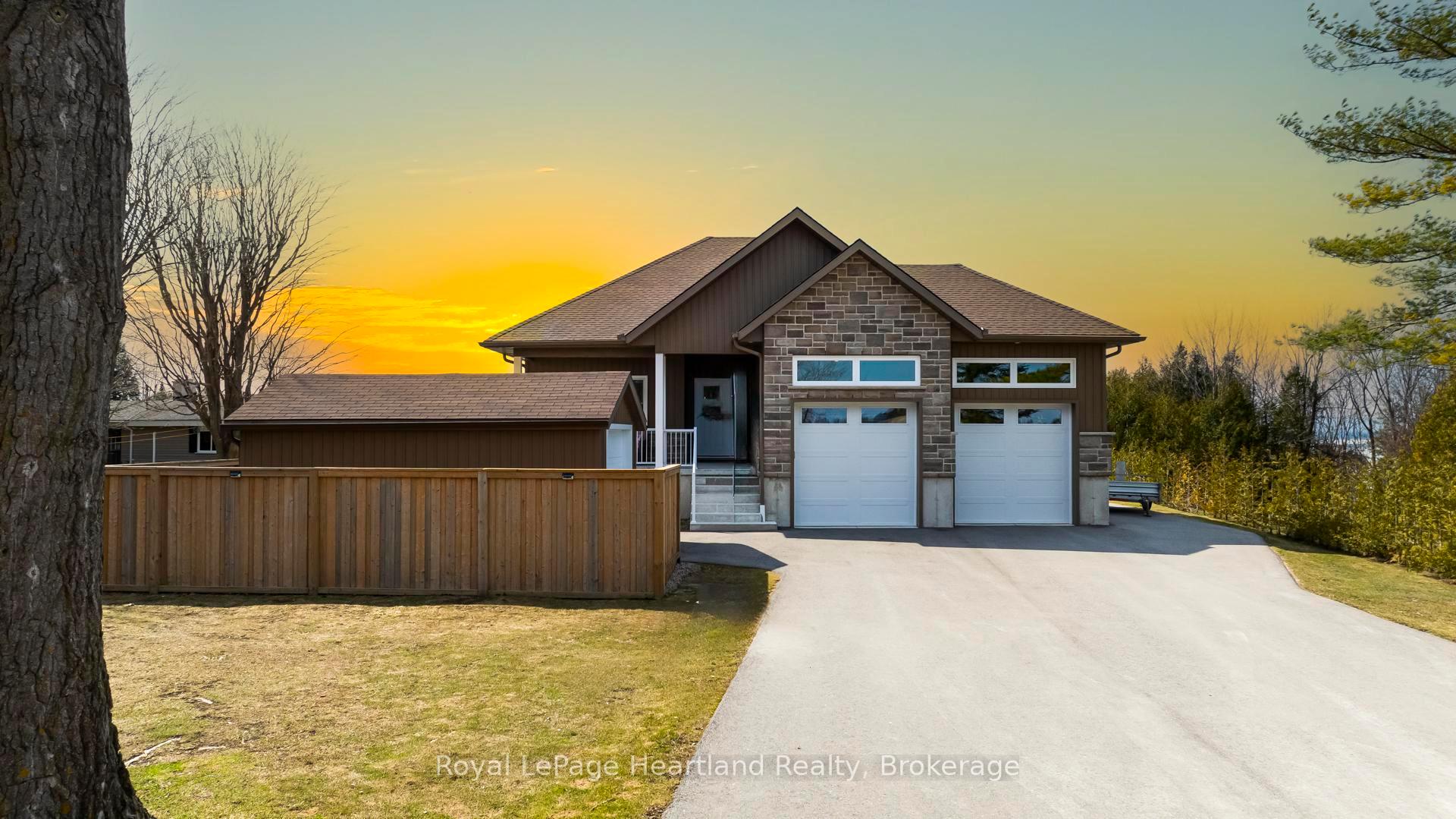 Experience Lakeside Living at Its Finest! This impressive raised bungalow, built in 2023, is designed for year-round enjoyment, seasonal getaways, or as a profitable rental investment. Located just steps from the water, this home offers the perfect blend of tranquility & convenience, just 18 minutes from Goderich & 20 minutes from Kincardine. Inside, you'll be welcomed by 9' ceilings & stunning inlaid tiles. The living room showcases a floor-to-ceiling stone fireplace, a 10' tray ceiling, & panoramic windows that flood the space with natural light. The kitchen is a chef's dream, featuring beautiful cabinetry, quartz countertops, stainless steel appliances, walk-in pantry. A 23'x16' lakeside deck offers unobstructed views of breathtaking Lake Huron, perfect for relaxing or entertaining. Conveniently located off the kitchen, the laundry & coat room leads into an oversized garage with 13.5' ceilings & a 9,000 lb car hoist ideal for car enthusiasts. The partially finished lower level with 8.5' ceilings is ready for your vision, featuring a roughed-in 4pc bath & foam insulation under the floor slab ideal for extra bedrooms or a family retreat. Sitting on a spacious lot, this home offers a peaceful escape with the security of a friendly lakeside community. Located on Huron Sands Rd., a Municipally maintained paved road, you'll enjoy the convenience of municipal water, garbage services, & year-round access. A 12' x 20' outbuilding at the front serves as a storage shed or potential bunkie while preserving your stunning lake view. With public access to a sandy beach just a 2-minute stroll away, this home truly embraces lakeside living. Plus, the numerous upgrades include- triple-pane windows, whole-house spray foam insulation, a new septic system, a 22W hardwired Generac generator, a reverse osmosis system, & iron filter. **ensure comfort and efficiency year-round. There's so much more to see -come experience this incredible home for yourself!