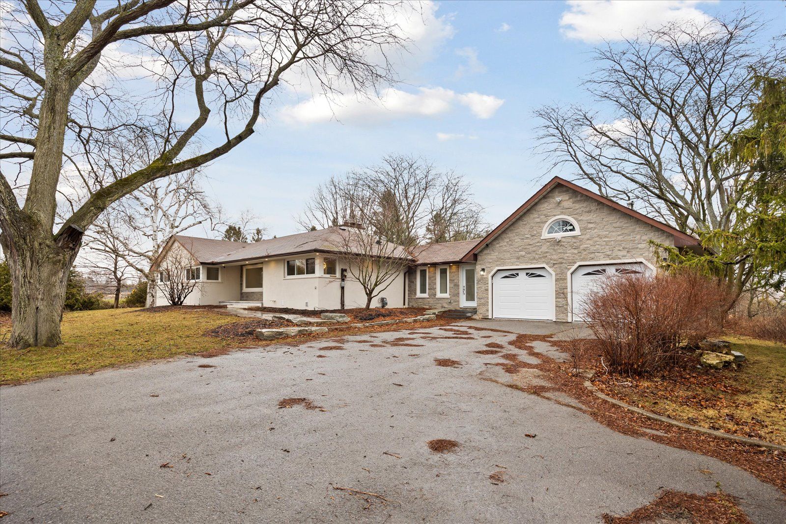 Ideal setting for a client requiring parking++ or separate space to run a home business in the finished walkout lower level or the option of an extended family home with 2 separate living quarters. All this plus 2095 sq. ft. of private living space on the main floor. Set on approximately one acre treed lot with no neighbouring homes in view yet quick access to Highway401, a few minutes drive to the shores of Lake Ontario and the village center of Newcastle. The house has been completely rebuilt with high quality finishings, workmanship and materials and never lived in since the renovations. Hardwood floors throughout both levels, quartz countertops, pot lights++, 2 stone fireplaces. Walkout from the kitchen to a huge entertainment sized deck overlooking the beautifully landscaped extensive stone patio with large landscape stones, treed ravine and creek beyond. Walkout from the lower level directly to a covered stone patio and gardens. A huge workshop area under the double garage is perfect for the hobbyist or storing your recreational vehicles. The double car garage is pristine having been coated with an epoxy flooring and is extra deep for additional storage with direct access to the house through a heated breezeway. A property like this doesn't come up often with proximity to the highway, local amenities, minutes to Lake Ontario and the private setting on a treed acre lot. Book your appointment today or risk being disappointed!