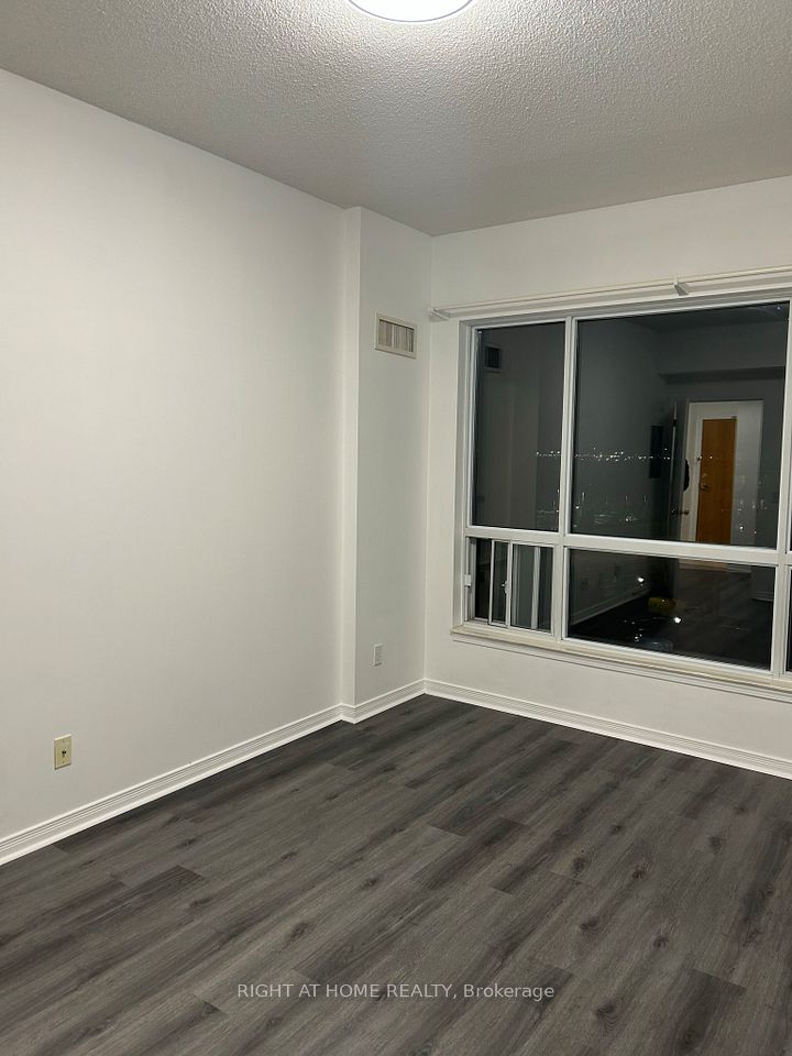generous-sized bedroom with large window