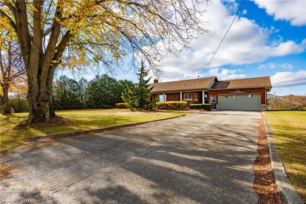 Ranch-style house featuring a double garage and a front yard