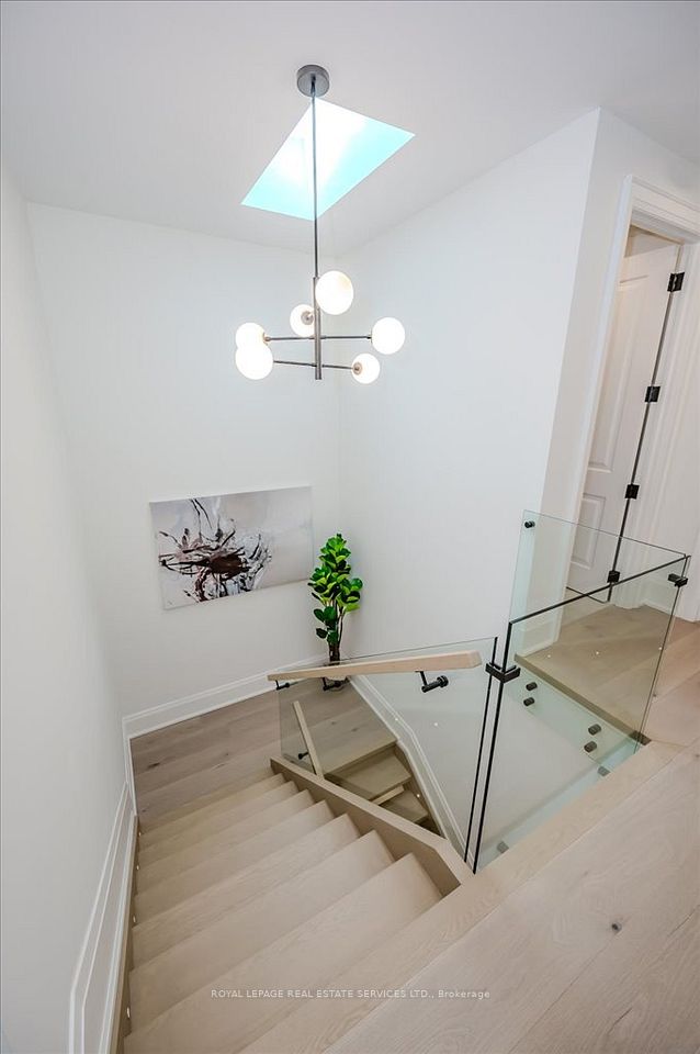 Custom Oak Staircases Illuminated by a Skylight