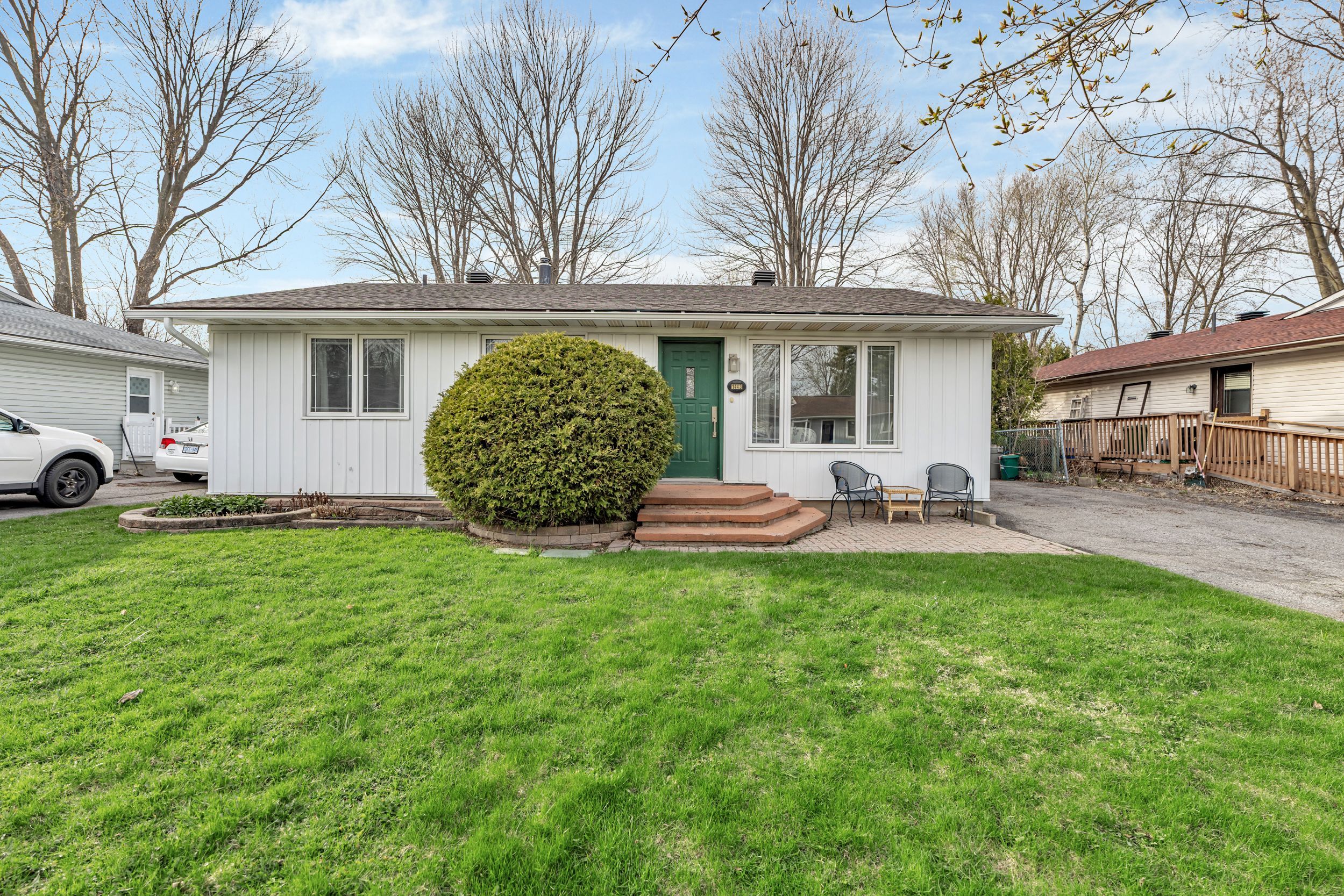 Welcome to 1443 Rainbow Crescent, a nicely updated bungalow in the sought-after community of Carson Grove. Set on a fully fenced (except driveway entrance to backyard), extra-wide lot, this home offers excellent flow and functional space for everyday living. The front entry foyer with tiled flooring leads into the living room with classic parquet flooring. Fresh paint updates in many rooms provide a clean and welcoming feel. The sunny living room offers plenty of space for relaxing or entertaining. The updated kitchen and dining area feature an open-concept layout, and through double glass French doors, you'll find a beautiful 3-season sunroom with vaulted ceiling, two skylights, and full wraparound patio doors - ideal for morning coffee or quiet evenings. Three generously sized bedrooms feature, large windows, and ample closet space. The renovated main bathroom includes heated floors for added comfort. A convenient side entrance leads to the kitchen and finished lower level. Downstairs features a large rec room with pot lights, an additional room ideal as an office or hobby space, and a stylish full bath with heated floors - perfect for guests or teens. There's also a large utility/storage room with workbench. The backyard is mostly fenced and includes a shed (as-is). Located near parks, schools, Montfort Hospital, and Aviation Parkway.  (all dates approx.): Roof 2023, Furnace & A/C 2019, Tankless HWT 2007, Windows 2005, Stove 2016, Dishwasher 2004, Washer 2024, Dryer (older). Taxes $4,556.92 (2024). Utilities: Hydro $111.40/m, Gas $85.00/m, Water $77.15/m. Built 1971. 24 hrs irrevocable on all offers. Some images are virtually Staged.