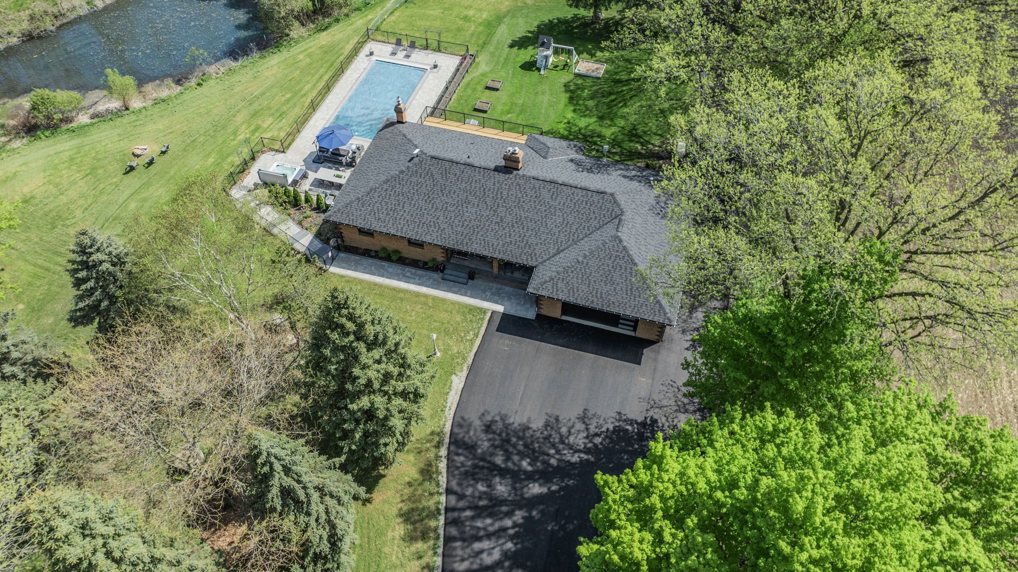 17365 10th Concession King, Ontario Your luxury country estate lifestyle begins here. Designed for multi-generational living and resort-style entertaining, this breathtaking property seamlessly blends elegance with the tranquility of nature. Wander along woodland walking trails, relax by the serene stream-fed pond, and indulge in poolside luxury with an outdoor kitchen and dining area where every day feels like a retreat. Step inside to find a beautifully designed home with high-end finishes and thoughtful details throughout. The gourmet kitchen is a chefs dream, featuring built-in appliances, a chefs pantry, and a sleek disappearing range vent. The open-concept layout allows for seamless flow between the kitchen, dining, and living areas, making it perfect for entertaining. For added flexibility, the fully finished walkout basement includes a second kitchen, providing the ideal setup for extended family, in-laws, or guests. A chair lift in the garage offers convenient access to the basement in-law suite.The backyard is an absolute showstopper, offering both privacy and endless recreational opportunities. Enjoy the scenic beauty of mature trees, walking trails, and a stream-fed pond, all within your own property. The saltwater inground pool with an automatic cover provides peace of mind, helps retain heat for a longer swim season, and offers effortless maintenance, while the saltwater hot tub adds another level of relaxation. Kids will love the inground trampoline and playset, while those looking for a self-sufficient lifestyle can take advantage of the chicken coop and spacious garden area. For extra storage and workspace, the property includes a workshop with its own electrical panel, gas line hookup, and loft storage, as well as a garden shed for added convenience.This estate is truly a one-of-a-kind retreat, offering the perfect blend of luxury, privacy, and multi-generational functionality. Every feature has been thoughtfully added to enhance comfort, convenience, and outdoor enjoyment.