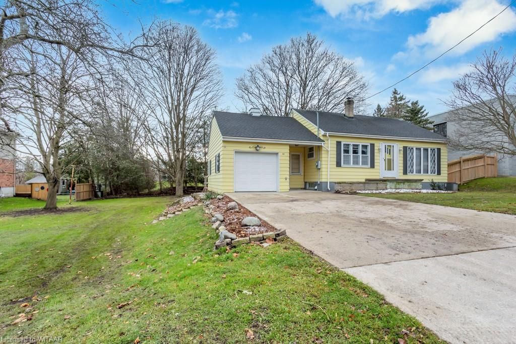Ranch-style home featuring a garage and a front lawn
