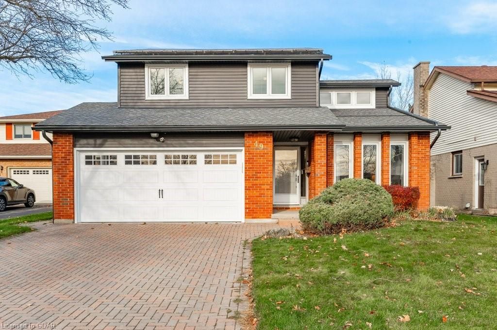 View of front of property featuring a front lawn and a garage