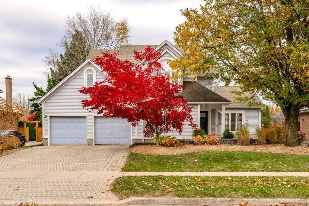 View of front facade featuring a garage and a front lawn