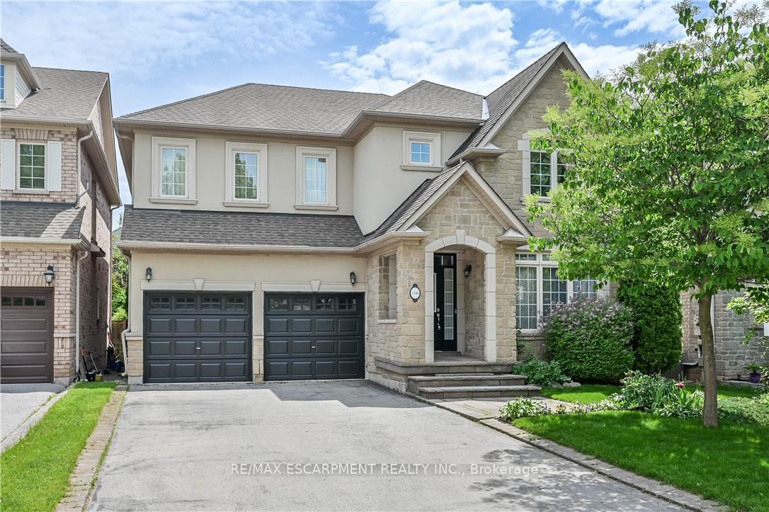 Nestled in the prestigious Lakeshore Woods community of Bronte West, Oakville, this exceptional home offers easy access to the scenic trails of Sheldon Creek and a serene walk to the lakefront. Just a short stroll away from Shell Park, you'1l enjoy access to pickleball and tennis courts, a dog park, splash pads, and soccer fields. This elegant 4-bedroom, 3.5-bathroom residence boasts a spacious, open-concept layout designed for modern living. The main floor features soaring ceilings in the family room, filling the space with natural light, and is complemented by a cozy two-way gas fireplace and gleaming hardwood floors. The chef-inspired kitchen is a true highlight, featuring granite countertops, stainless steel appliances, a stylish kitchen sink, and beautifully crafted glass-front cabinetry. Step outside into the private, professionally landscaped backyard-a peaceful retreat surrounded by mature trees that offer complete seclusion. The backyard also includes a gas line for barbecues, perfect for effortless outdoor entertaining. With no sidewalks, the driveway provides ample parking for up to 4 cars, with additional space for 2 more in the garage, which includes convenient inside entry. This floor for home is meticulously detailed, showcasing stunning crown molding throughout. The main also includes a convenient laundry room and powder room. The basement offers a rough-in a 3-piece bathroom, providing endless potential for customization. This home is a true reflection of pride of ownership, with exceptional craftsmanship and attention to detail throughout.
