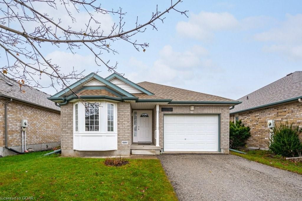 View of front facade with a front yard and a garage