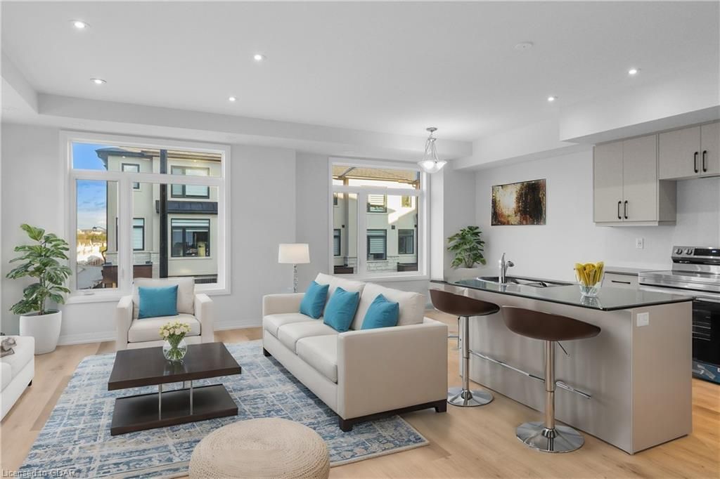 Living room featuring sink, plenty of natural light, and light hardwood / wood-style flooring